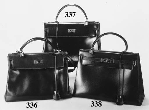 A KELLY HANDBAG OF NAVY BLUE HANDBAG, WITH PADLOCK AND KEYS, HERMS PARIS--13IN. (33CM.) BASE; AND A HANDBAG OF BLACK CROCODILE SKIN, IN THE FORM OF AN ENVELOPE, WITH A DETACHABLE STRAP, STAMPED MADE IN FRANCE--9IN. (23CM.) BASE