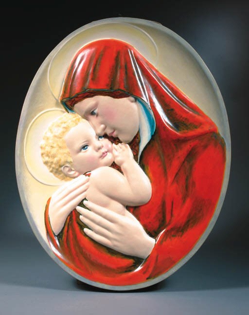 A glazed porcelain mural tablet of the Madonna with Child