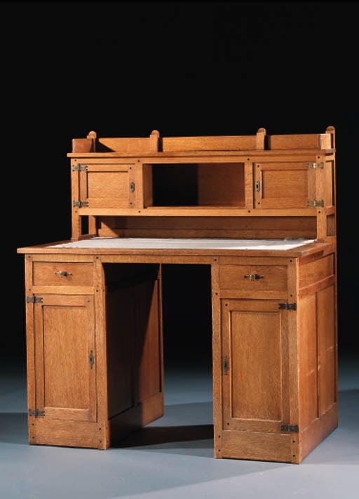 A PANELLED OAK TWIN-PEDESTAL DESK