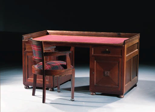 A MAHOGANY AND COROMANDEL TWIN-PEDESTAL DESK AND ARMCHAIR