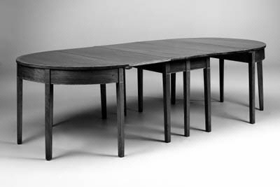 A mahogany crossbanded and line-inlaid dining table