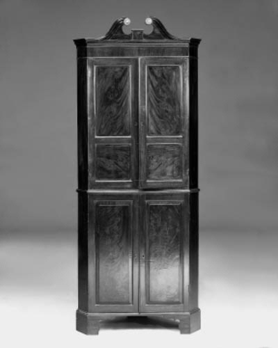 A mahogany standing corner cabinet, parts 18th century
