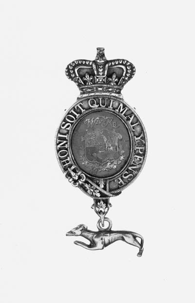 KING'S MESSENGER BADGE, W.IV.R., 94 x 44mm., oval silver-gilt Badge (Hallmarks for London, 1824) with Royal Crown above and pendant silver Greyhound below, obverse with painted Royal Arms and  W.IV.R. cypher, reverse inscribed, 'Edward Pratt, July 1824', damage to painted shield, about very fine and rare