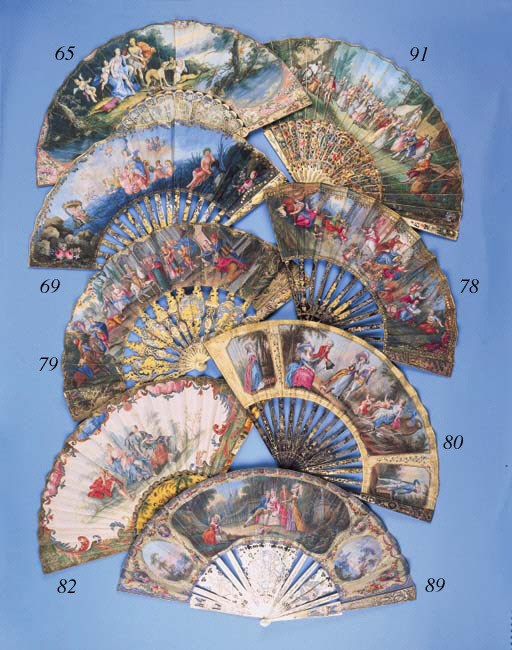 The Triumph of Venus, a painted fan, the verso with two ladies and a gentleman playing the guitar, the mother of pearl sticks carved, pierced and gilt with lovers, a flautist and putti - 10in. (26cm.), French, circa 1760 (old repairs to two sticks, slight damage to verso of leaf)