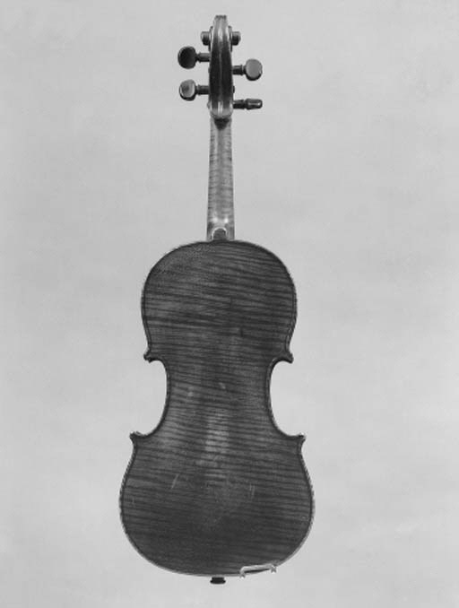 An interesting violin with illegible label dated 1789; the one-piece back of strong narrow curl, the ribs and scroll of medium curl, the varnish of a red colour, the length of back 14in (355mm)