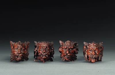 A SET OF FOUR NORTH EUROPEAN RENAISSANCE STYLE WALNUT GROSTESQUE MASKS