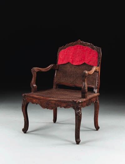 AN EARLY LOUIS XV BEECHWOOD FAUTEUIL A LA REINE