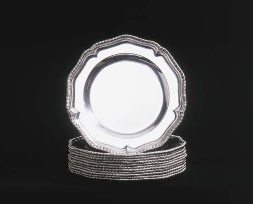A SET OF TWELVE GEORGE II SILVER DINNER PLATES OF HEAVY GAUGE