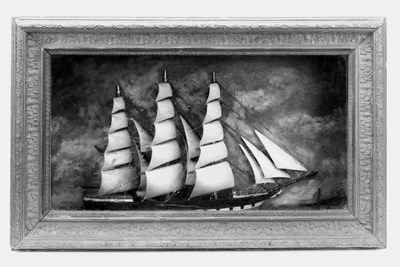 A 19th Century sailor's picture half model of a three-masted full rigged ship shown sailing in a port reach