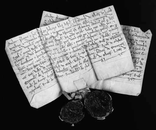 ENGLISH CHARTERS. A pair of charters, n.d. [late 12th - early 13th Century]. Juliana and Maria, widows, daughters of Nicholas de Thorpe [nr Ashbourne, Derbyshire], each selling half a carrucate of land in Newton [in the parish of Ashbourne] to the monastery of Combermere, by royal writ of the court of William de Ferrers, Earl of Derby, for 'una[m] marcam arg[e]nti et una[m] vacca[m]', on vellum, in Latin, in a clear and elegant charter hand, annotated on verso 'Juliane [Marie] Filie Nichol[ai]' and 'Newton', each approximately 95 x 165mm (light staining and puncture at fold to charter of Juliana; small loss, not affecting text, to upper margin of charter of Maria), two fine heavy seals, 'Sigillu[m] Geliane de Torp' and 'S[igillum] Marie F[ilie] Nicholai', pendant from interlocked vellum tags (two minor peripheral losses to seal of Juliana).