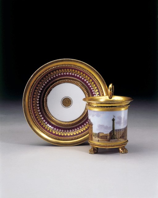 A PARIS GOLD AND CLARET-GROUND TOPOGRAPHICAL CUP AND SAUCER