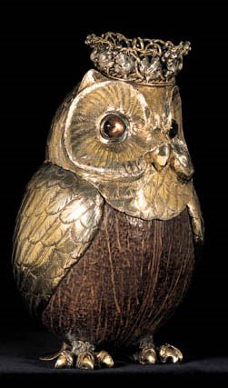 A GERMAN SILVER-GILT MOUNTED COCONUT CUP AND COVER FORMED AS AN OWL