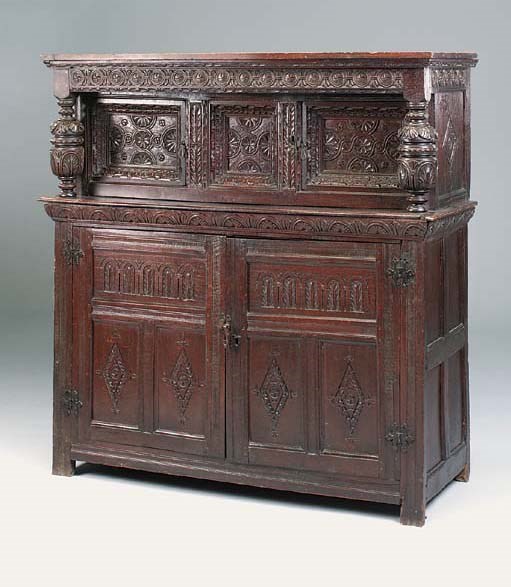 A carved oak press cupboard, North Country, early 17th century