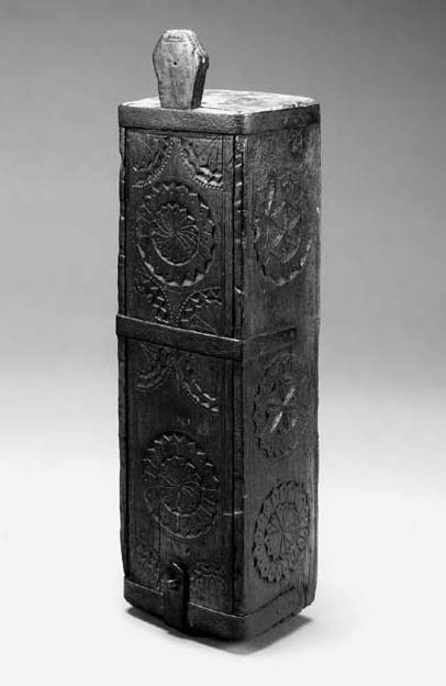 A chip-carved wood and wrought-iron bound candle box