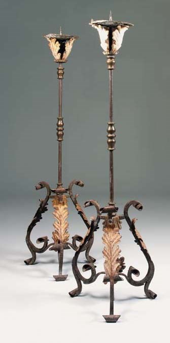 A pair of North European wrought-iron and bronze mounted floor standing pricket candlesticks