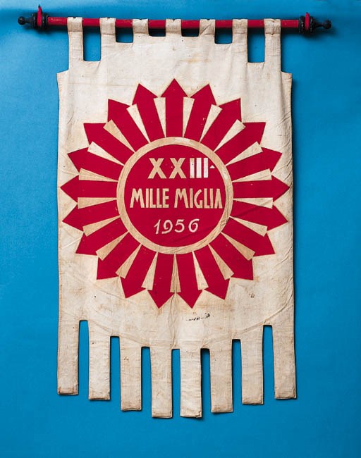 Mille Miglia 1956 - An original banner for this famous road-racing event; decorative stencil-printed motif on canvas; original pole mounting; removed from the square in Brescia after scrutineering reception, by an enthusiast.
