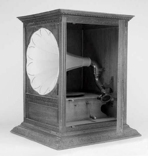 A Pathé Salon No. 3 talking machinewith (repainted) pink flower horn, Ebonite soundbox and 8-inch turntable, in stained beech case with flat top, embossed mouldings and side access door -- 24½in. (62cm.) high