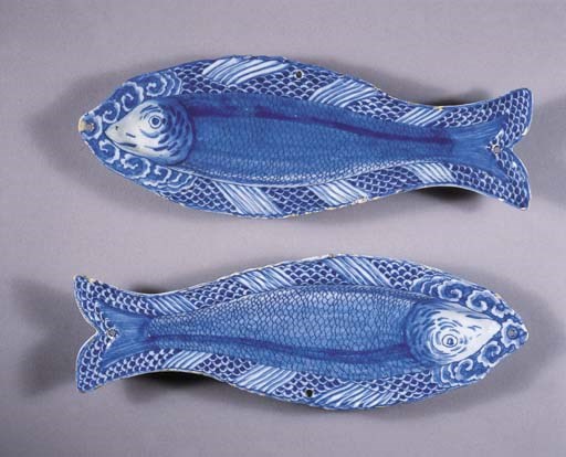 A pair of Dutch Delft blue and white tripod herring dishes