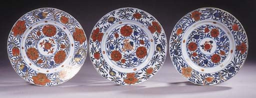 A set of six Chinese blue and white 'clobbered' dishes
