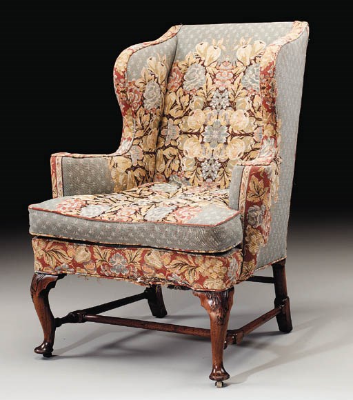 A GEORGE I WALNUT AND BEECHWOOD WING ARMCHAIR