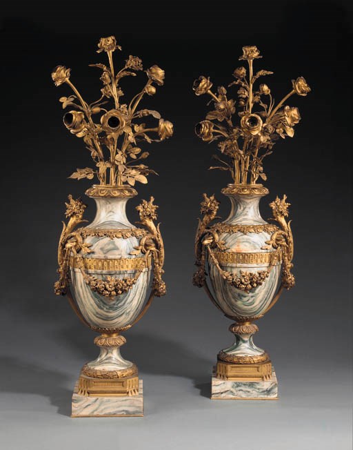 A pair of French gilt-bronze and Cippolino verde six-light candelabra
