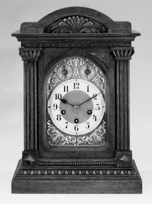 A German carved oak quarter-chiming mantel clock, early 20th century