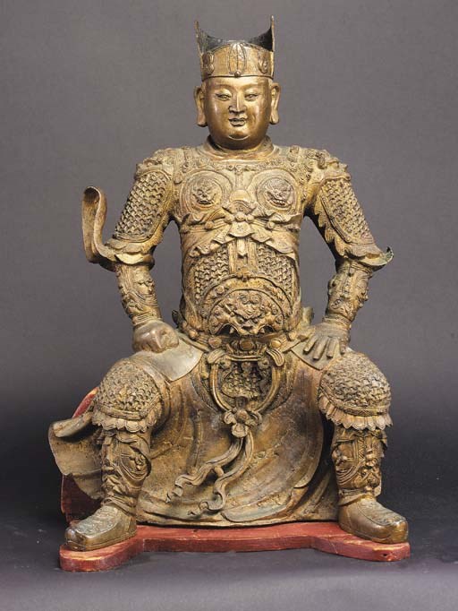 A Chinese gilt-bronze figure of a seated warrior,