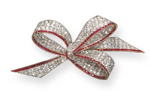AN ELEGANT BELLE EPOQUE DIAMOND AND RUBY BOW BROOCH