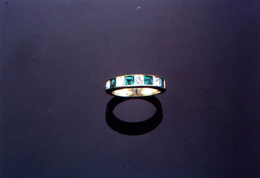 AN EMERALD AND DIAMOND RING, BY TIFFANY AND CO.