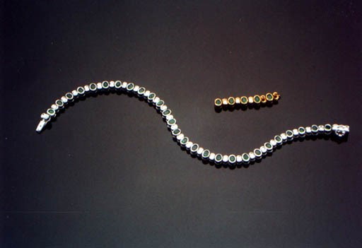 AN EMERALD AND DIAMOND LINE BRACELET