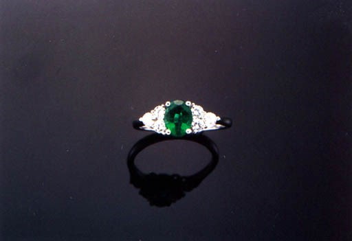 AN EMERALD AND DIAMOND RING