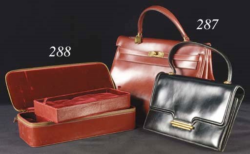A Mefisto handbag of black leather, the hinged clasp gold plated, the metal stamped with French assay marks, the interior lined with black kid leather and fitted with pockets, stamped HERMES PARIS--10in. (25.5cm.), circa 1955, probably designed by Robert Dumas, very gently worn