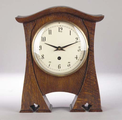 An Arts and Crafts wooden mantle clock