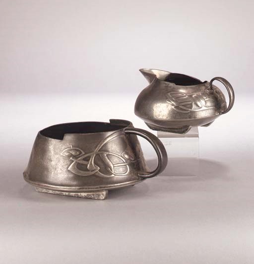 A Liberty Tudric pewter cream jug and single handled sugar basin