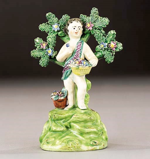 A Walton figure of a putto