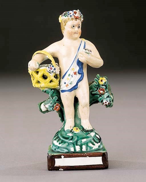 A pearlware figure of a putto