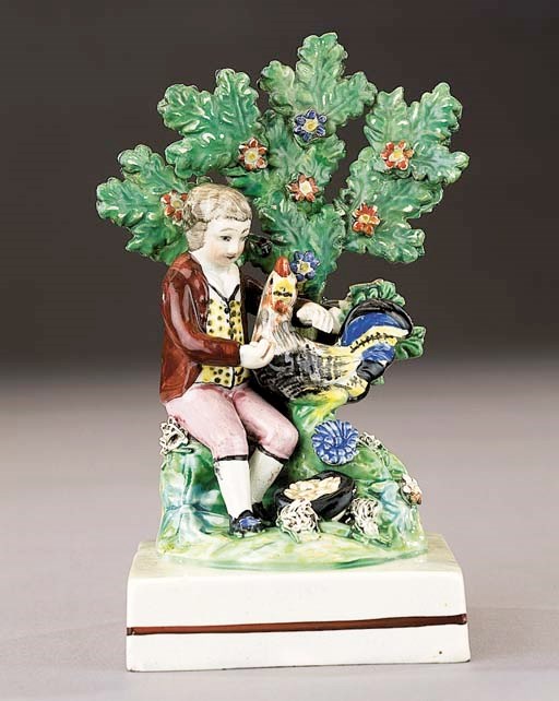 A pearlware figure of a boy