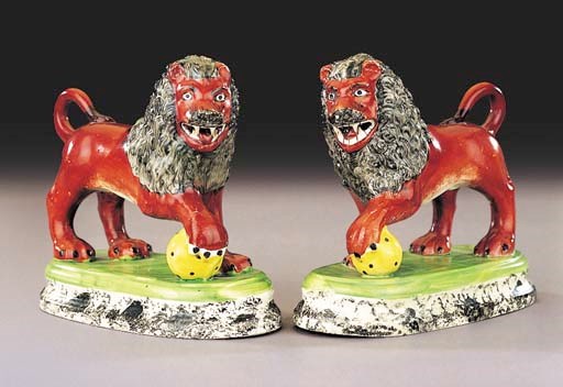 A pair of pearlware models of lions