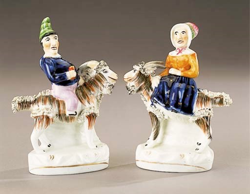 A pair of groups of Punch and Judy seated on goats