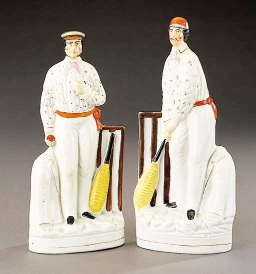 A pair of figures of cricketers