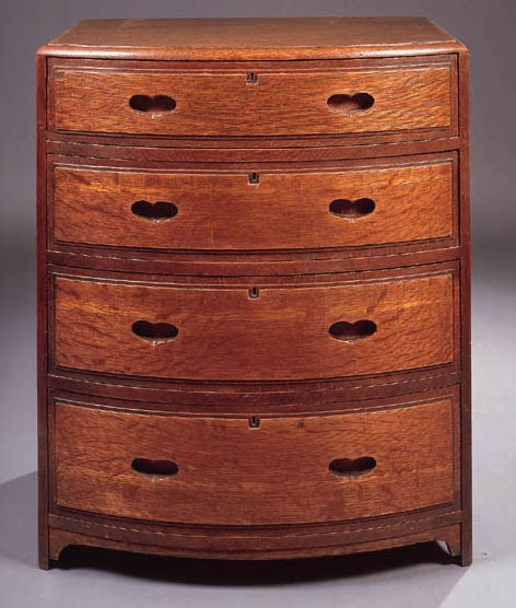 AN OAK BOW-FRONT CHEST OF DRAWERS