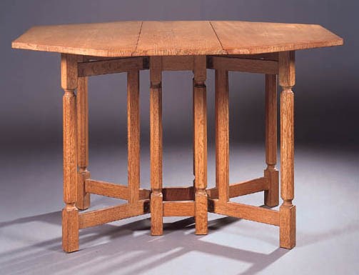 A LIMED OAK GATE-LEG TABLE