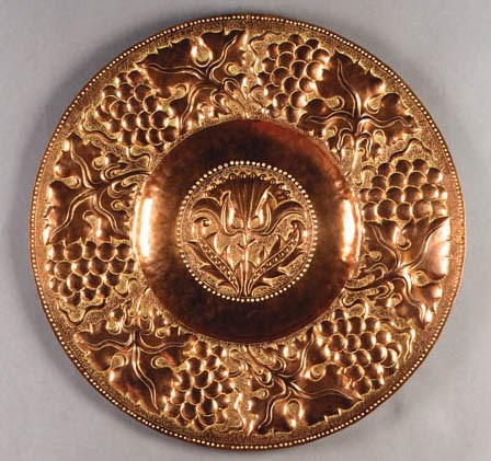 A COPPER WALL CHARGER
CIRCA 1895
