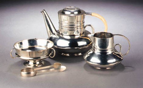 A LIBERTY & CO SILVER AND IVORY FOUR PIECE TEASET
DESIGNED BY ARCHIBALD KNOX, BIRMINGHAM 1905
