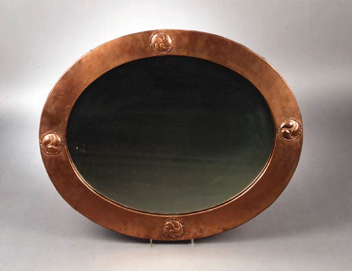 A LIBERTY COPPER AND WOOD WALL MIRROR
CIRCA 1900