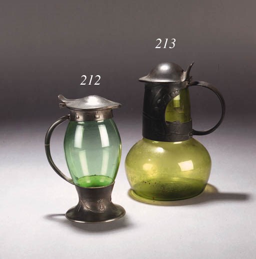 A LIBERTY TUDRIC PEWTER EWER WITH POWELL GREEN GLASS LINER
DESIGNED BY ARCHIBALD KNOX, CIRCA 1902-1905