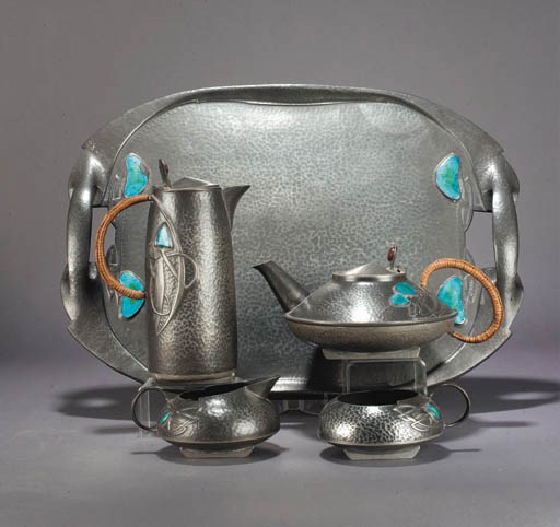 A LIBERTY TUDRIC PEWTER AND ENAMEL FIVE PIECE TEASET
DESIGNED BY ARCHIBALD KNOX, DESIGNED 1902-1905