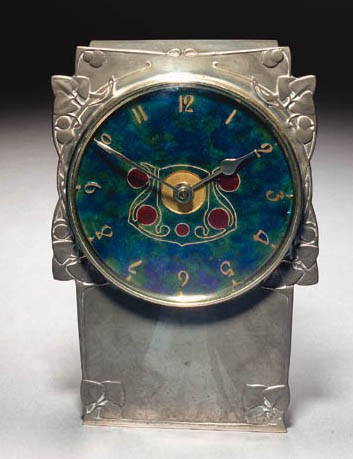 A LIBERTY & CO PEWTER AND ENAMEL MANTLE CLOCK
DESIGNED BY ARCHIBALD KNOX, CIRCA 1902-1905