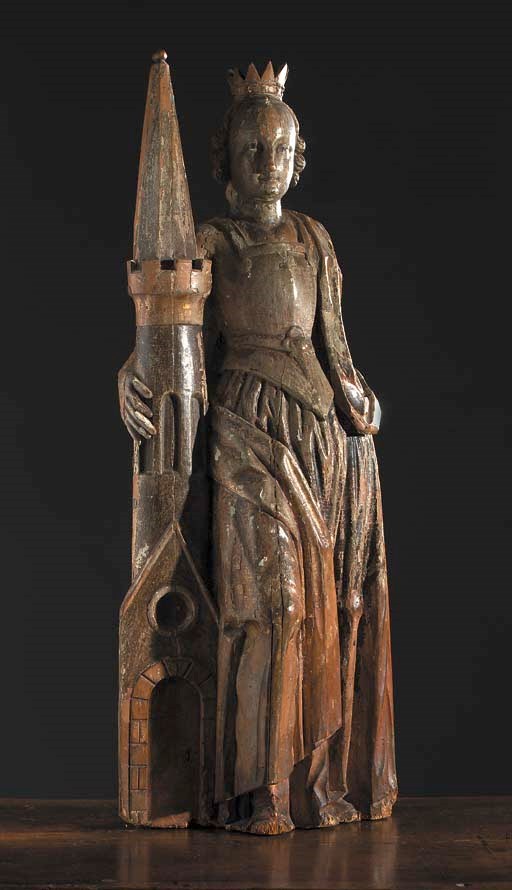 A polychrome carved wooden figure of St. Barbara
