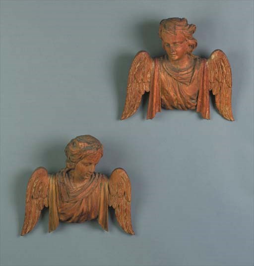 A pair of carved fruitwood angels
